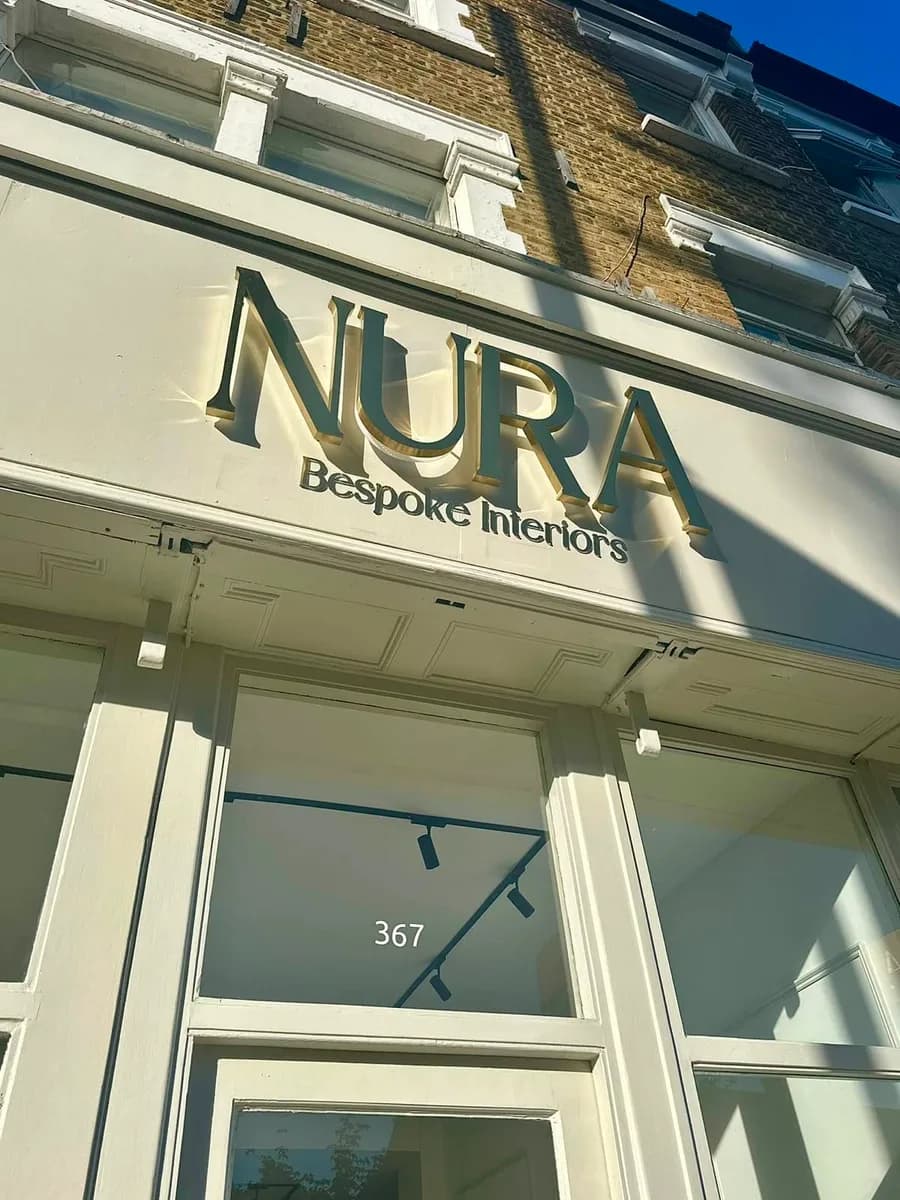 Nura Bespoke Interiors sign above the entrance at 367 Fulham Palace Road, London