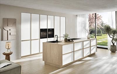 Light kitchen with a timber island, tall cabinets and garden doors