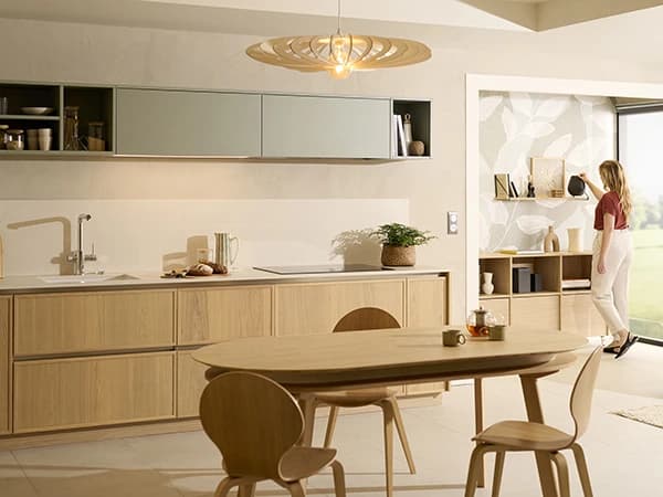 Timber kitchen cabinetry and a dining table with chairs