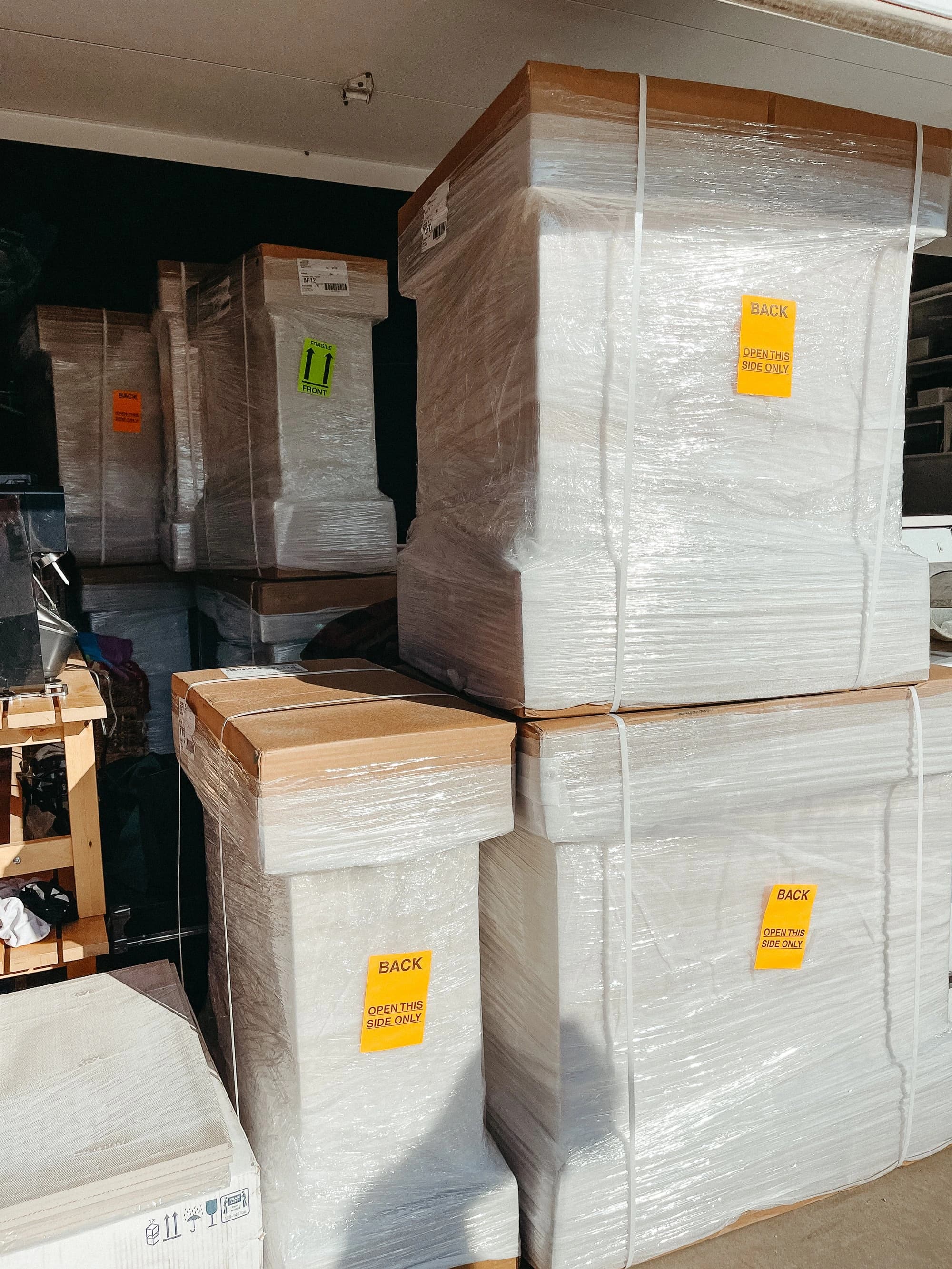 Wrapped cabinets and stacked components in a warehouse