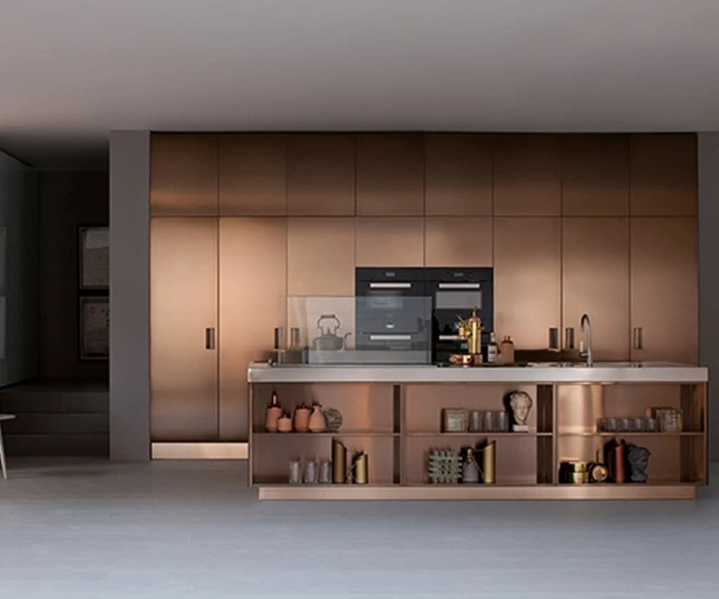 Copper-toned cabinetry with a central island and built-in ovens