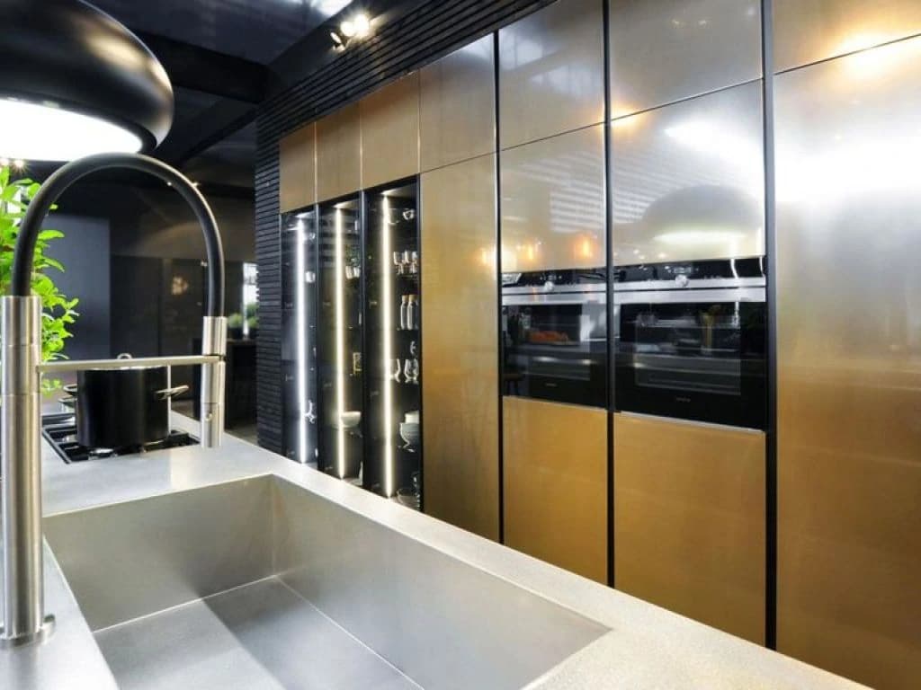 Bronze-toned cabinets and built-in ovens in a display kitchen