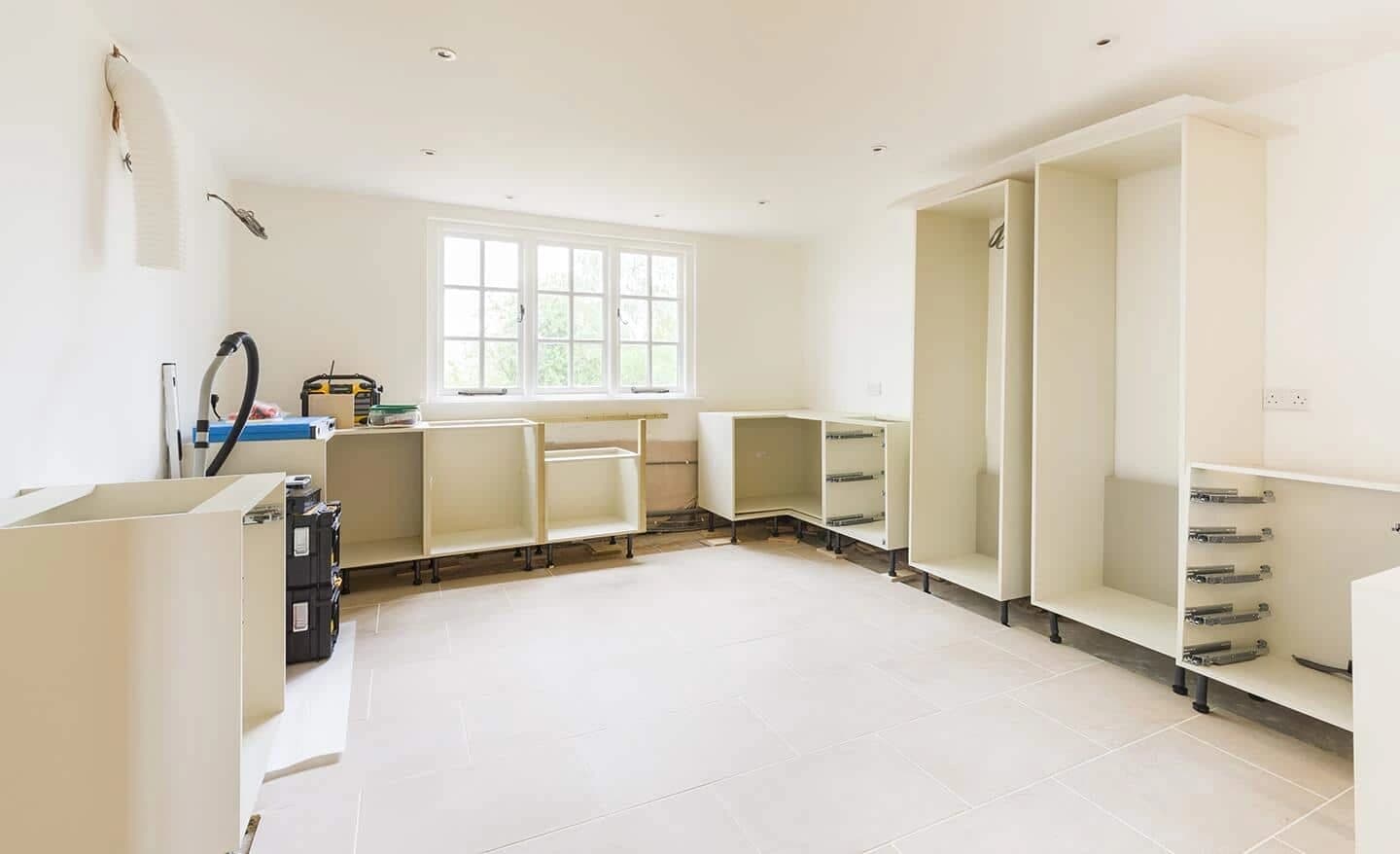 Kitchen base cabinets and tools during installation