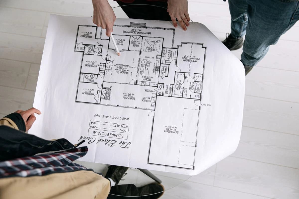 Hands holding a detailed floor plan