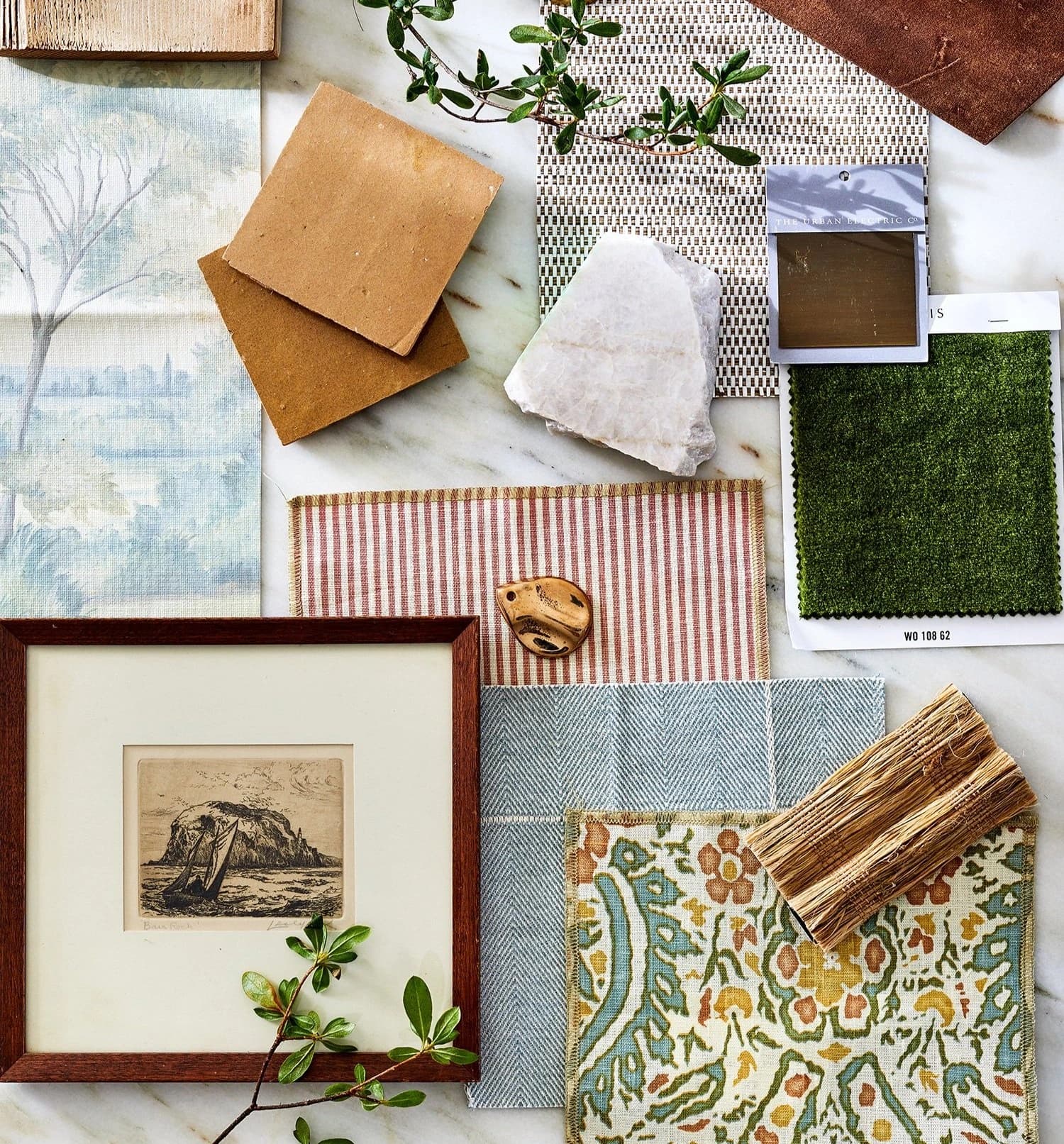 Interior material samples and a colour palette on a table