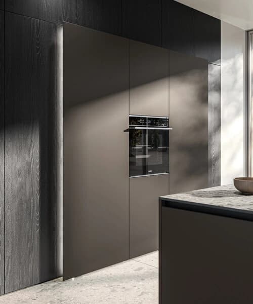 Dark tall kitchen cabinets with a built-in oven