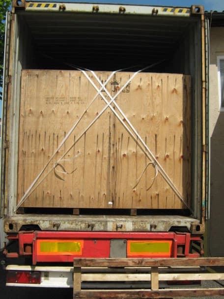 Wooden shipping crate secured inside a freight container