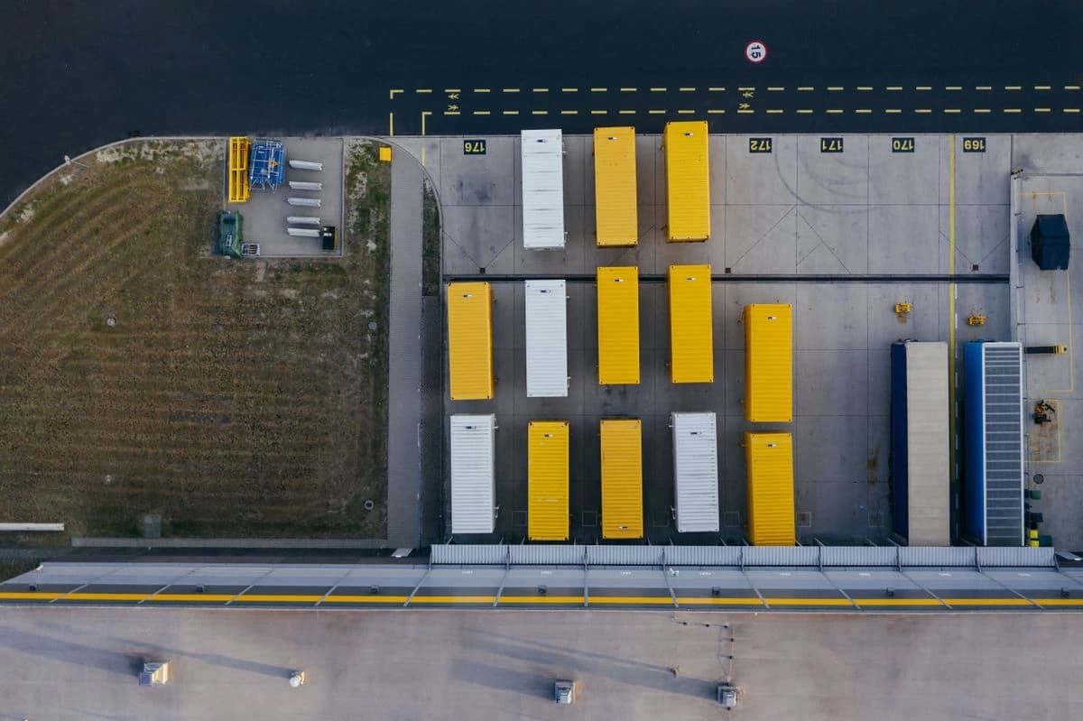 Aerial view of freight containers beside a road