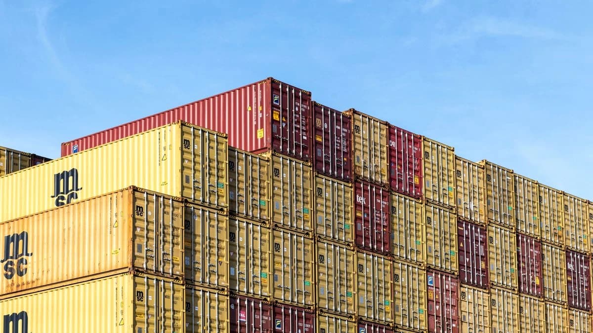 Stacks of multicoloured shipping containers at a terminal