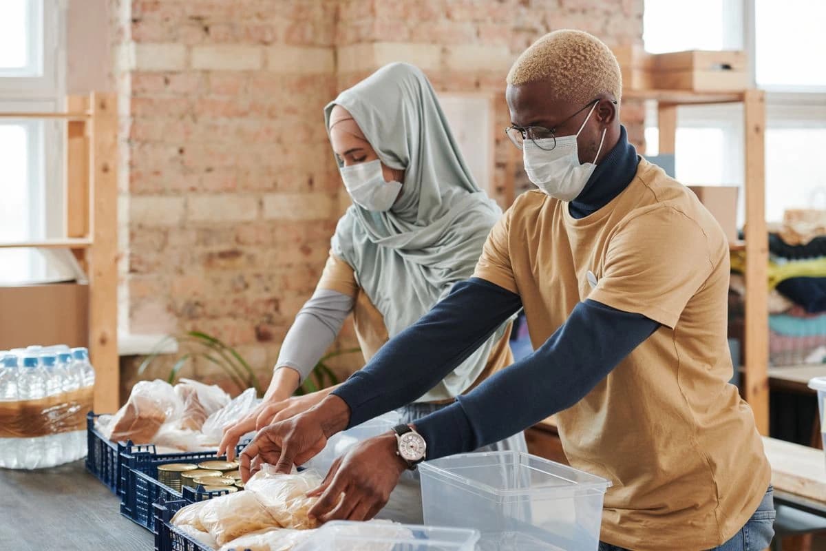 Two people packing supplies into boxes