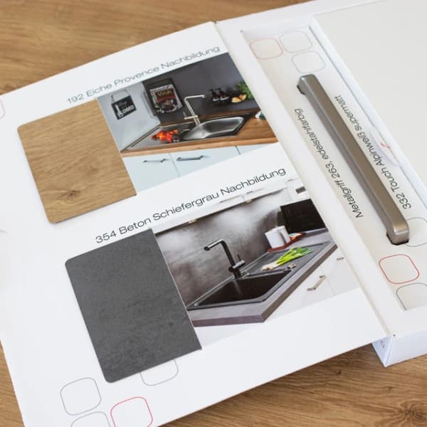 Kitchen brochure beside cabinet handle and surface samples