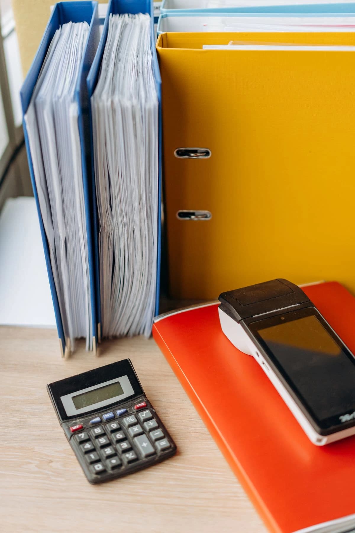 Calculator and folders on a desk