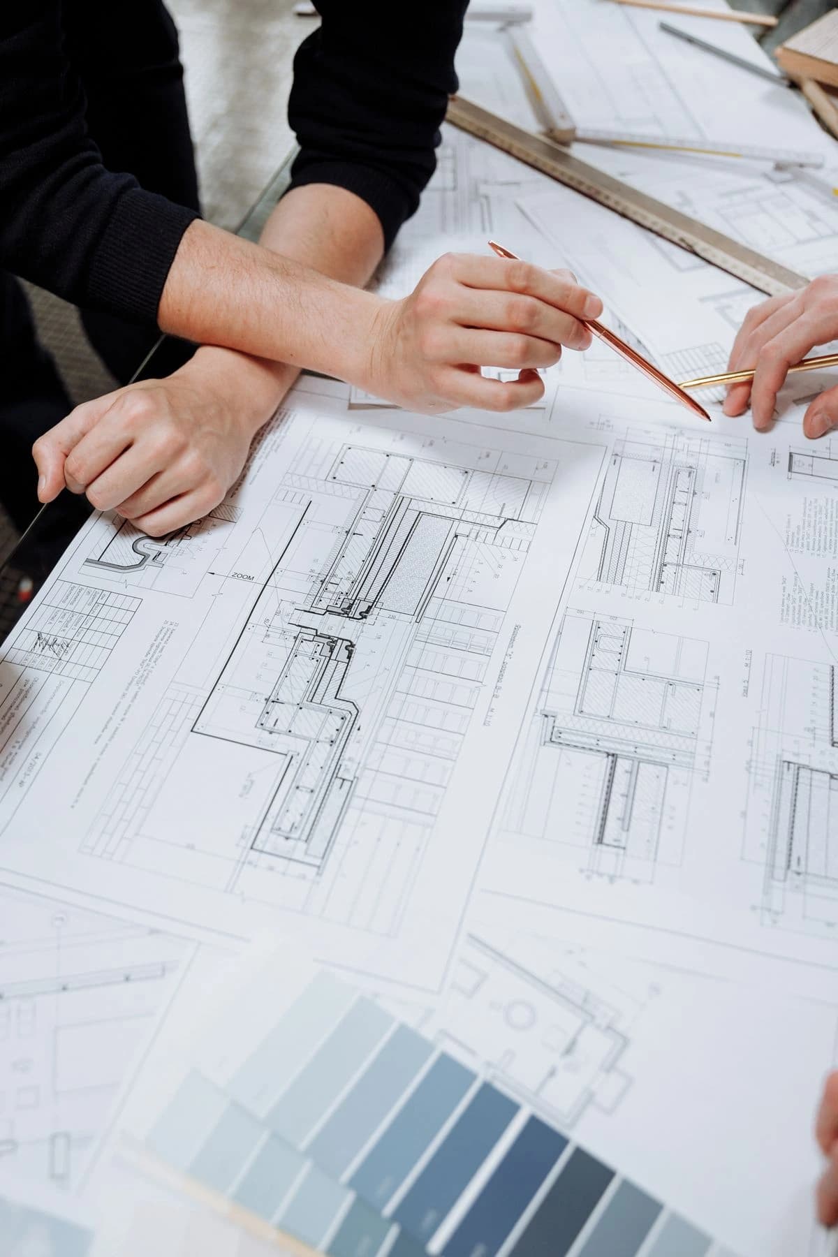Hands reviewing architectural drawings