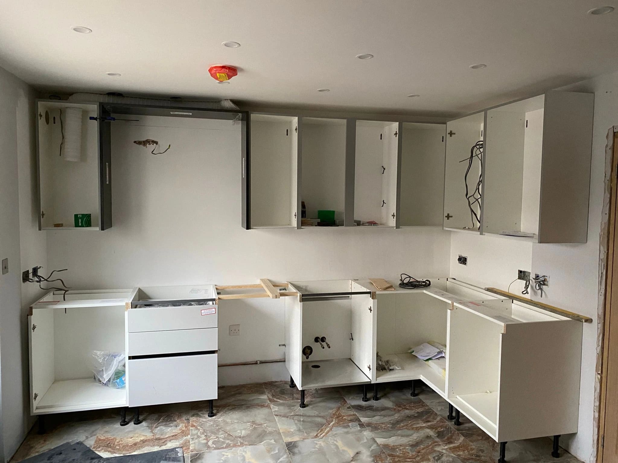 Partly fitted kitchen cabinets and unfinished walls