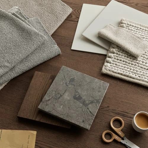 Fabric, stone, timber and colour samples arranged on a table