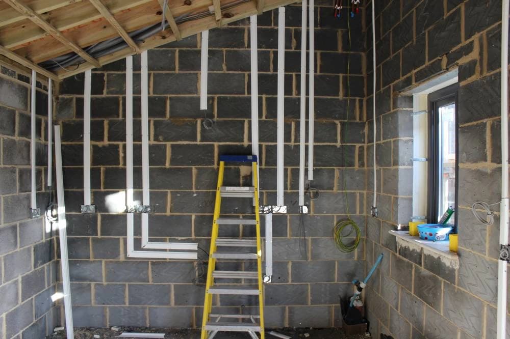 Exposed framing and services during kitchen construction