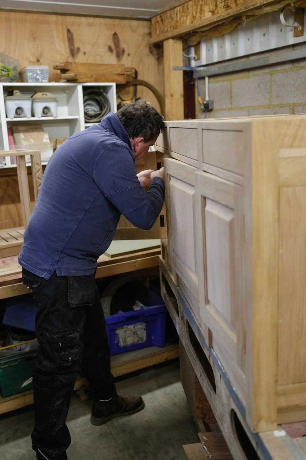 Person checking a cabinet in a workshop