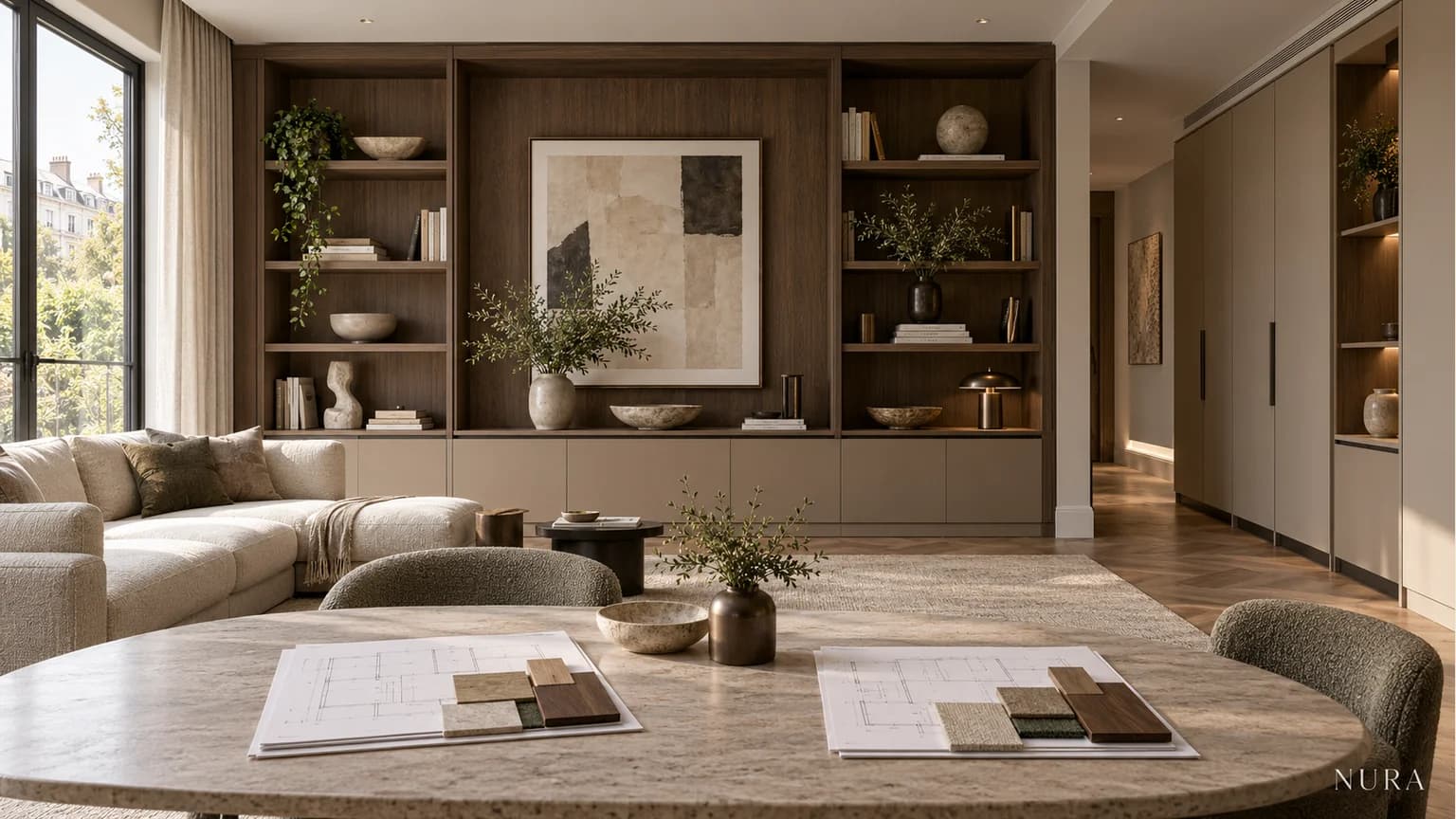 Two drawing packs and material samples on a stone table in front of oak and clay fitted cabinetry