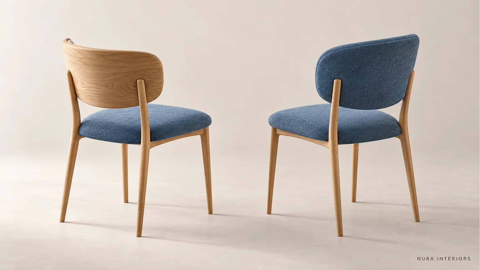 Two blue-seated oak dining chairs, one with a timber back and one with an upholstered blue back