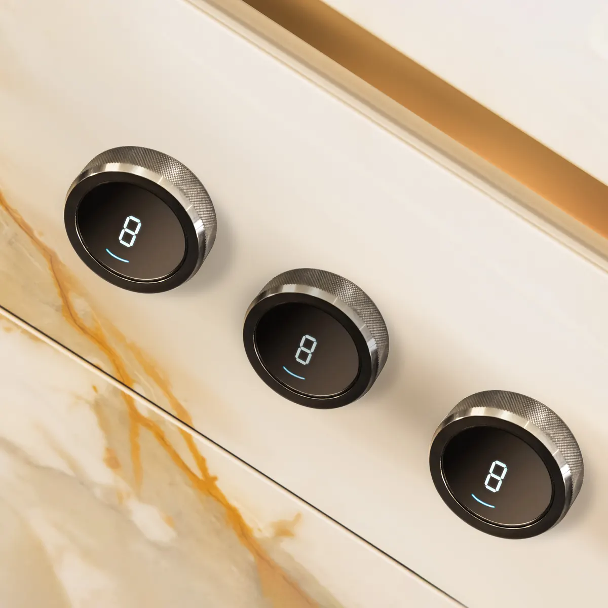 Three circular appliance controls integrated into a light-coloured kitchen panel