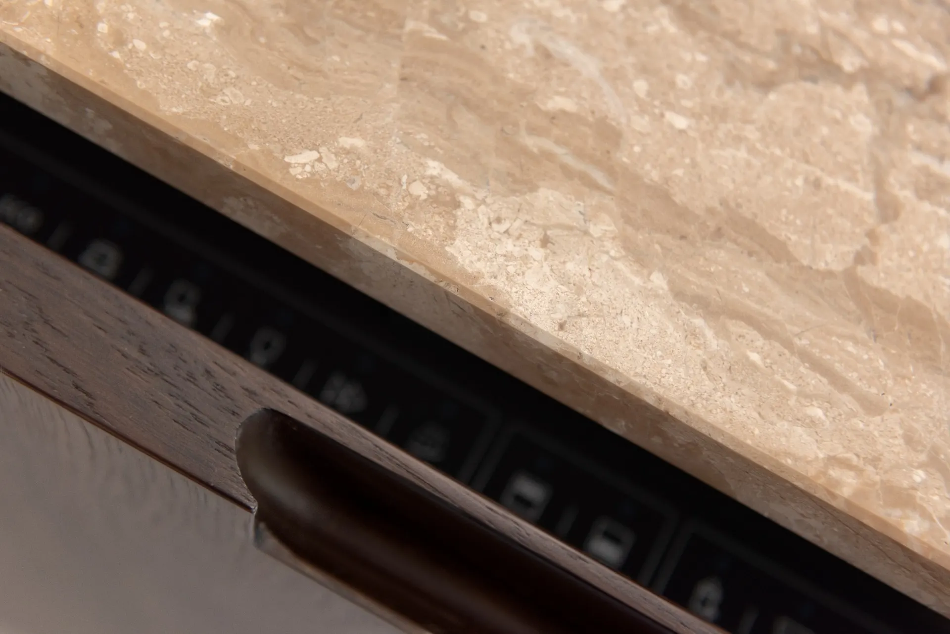 Detailed kitchen drawer with timber storage and integrated controls
